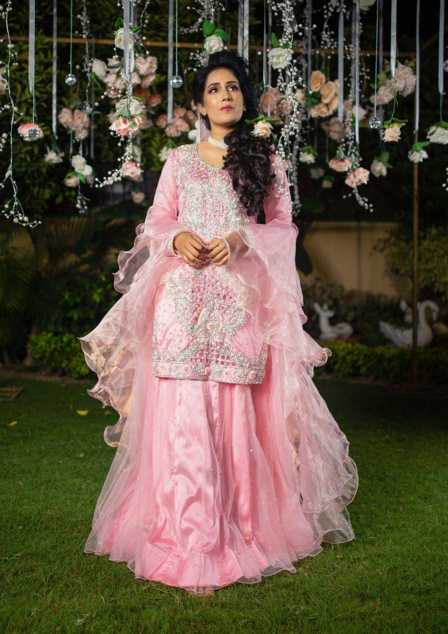 Pastel pink tone shirt with heavily stones and cutwork on it paired with plain net lehnga enhance the look. Organza layered dopata make the look according to the demand.