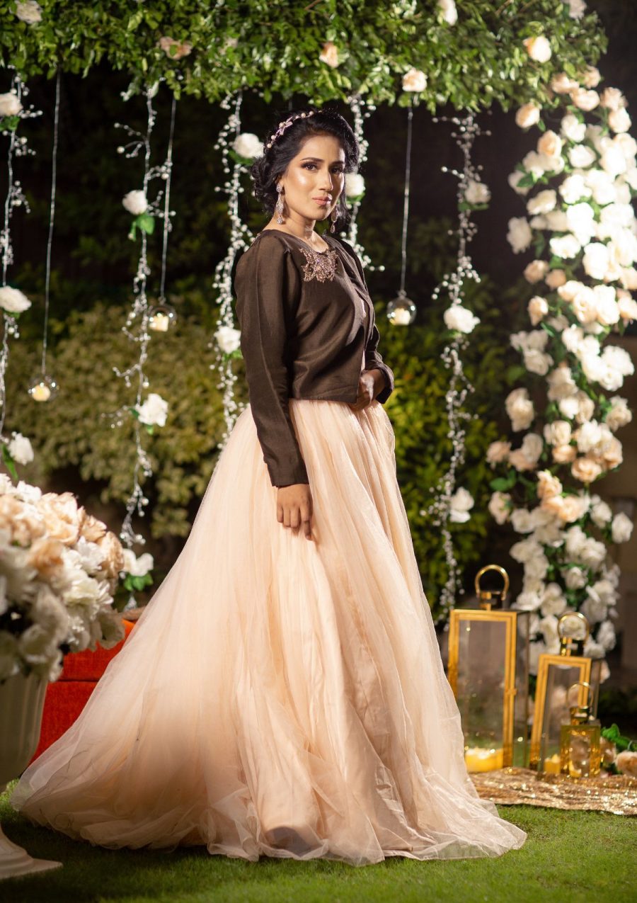 Dreamy Peachy long flared stylish cutline gown on net fabric with belaro jacket in pure raw silk fabric and bit embellishment on it in contrasting shade.