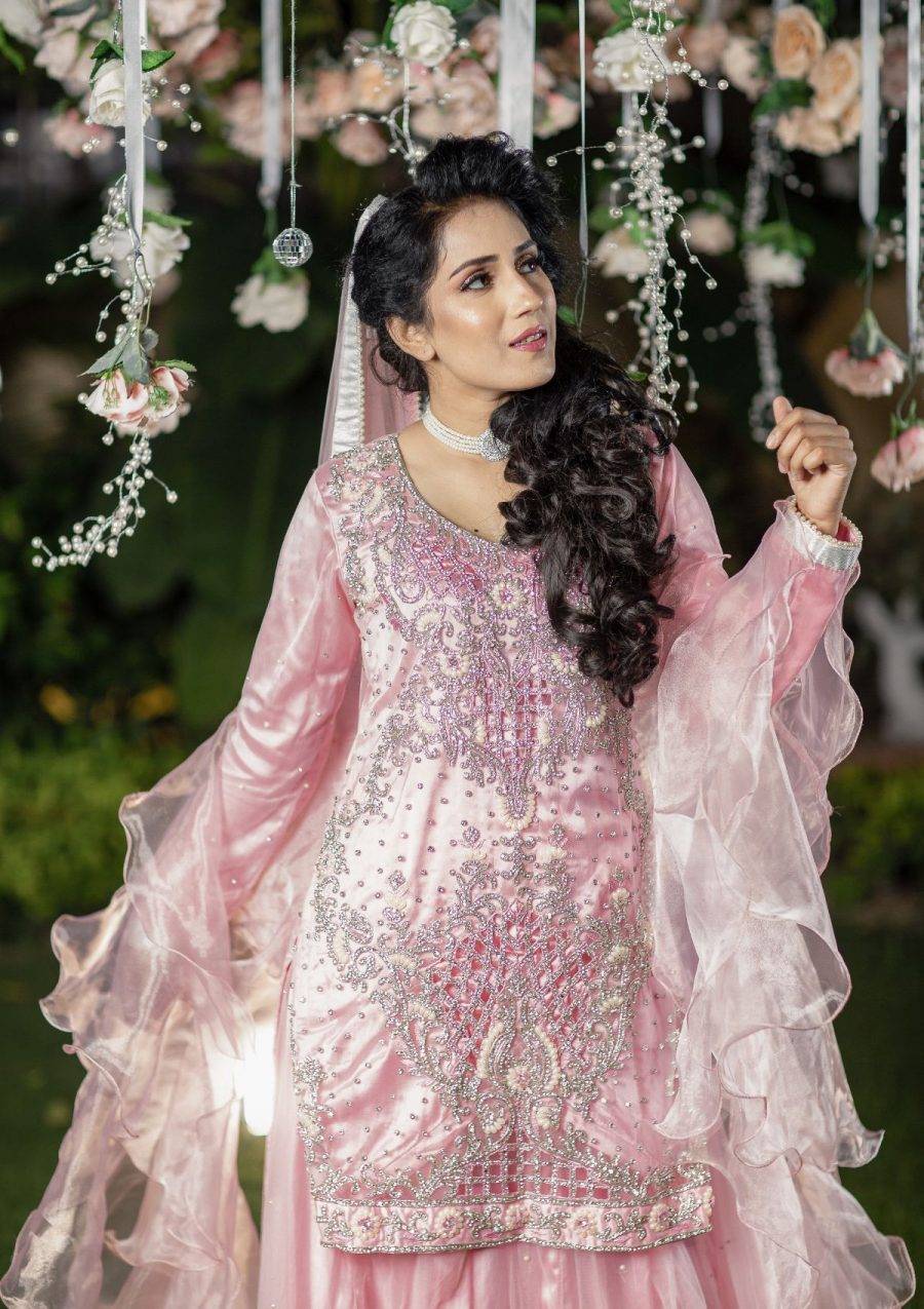 Pastel pink tone shirt with heavily stones and cutwork on it paired with plain net lehnga enhance the look. Organza layered dopata make the look according to the demand.