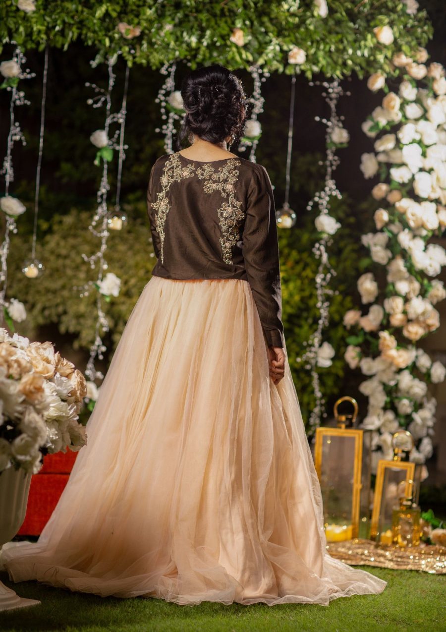 Dreamy Peachy long flared stylish cutline gown on net fabric with belaro jacket in pure raw silk fabric and bit embellishment on it in contrasting shade.
