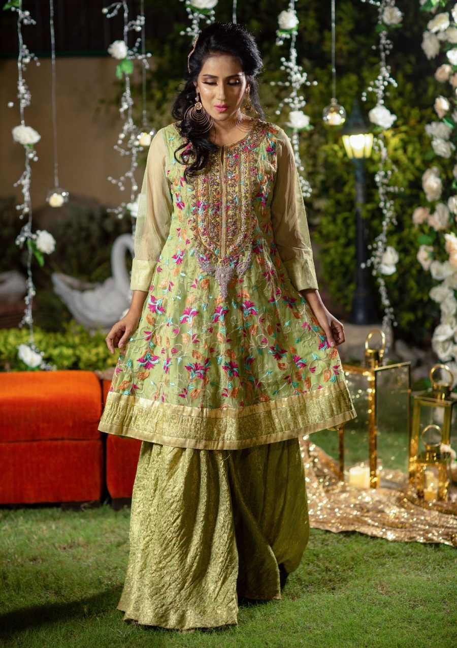 Light grren jamawar gharara style with A-Line pannelled shirt in net fabric having multi color embroidery and heavily embellished neckline of tilla, naqshi, dapka, stonework on it.