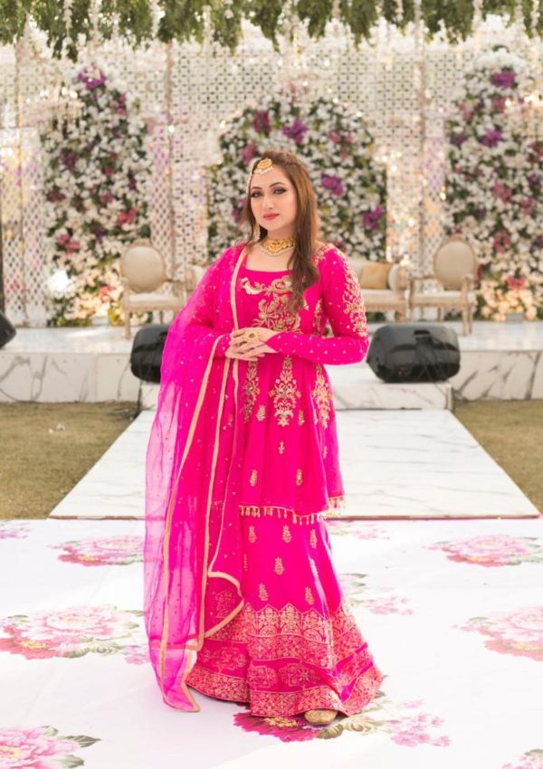 Pure organza peplum style shirt with gold handwork of naqshi, dapka, tilla, sequences on its front and spray of sequences on sleeves paired with pure raw silk block printed and hand work sharara of same pink tone having organza dopata with spray of sequence on it. Finishings of drops on hem of shirt.