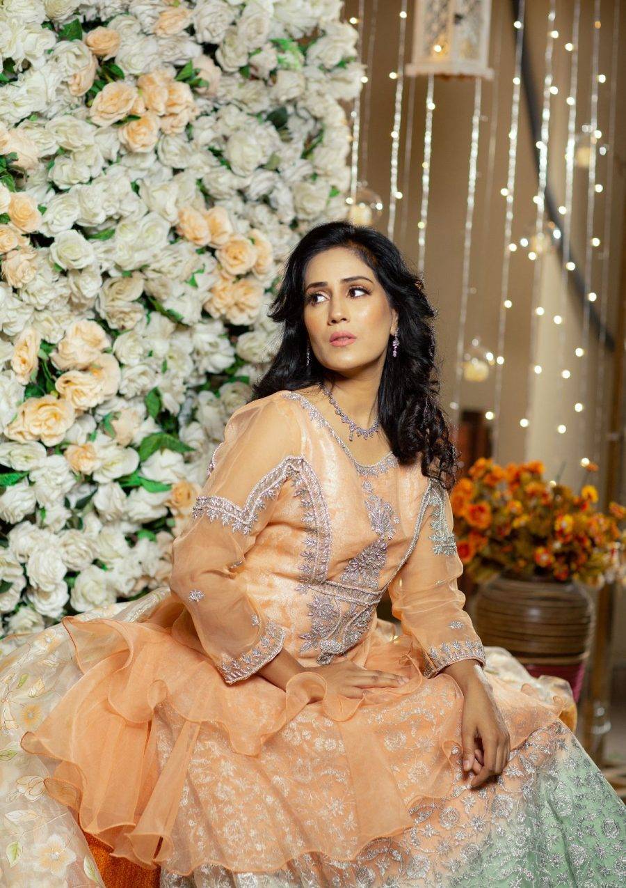 Peachy stylish flared short length peplum in organza fabric with silver hand work of naqshi, dapka, stones on it paired with peach and green shaded tye and dye fully embroidered net lehnga with silver tilla work on it also having printed organza dopata makes the look perfect for the wedding season.
